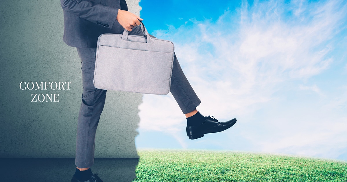 Man in suite with briefcase stepping out of his comfort zone.